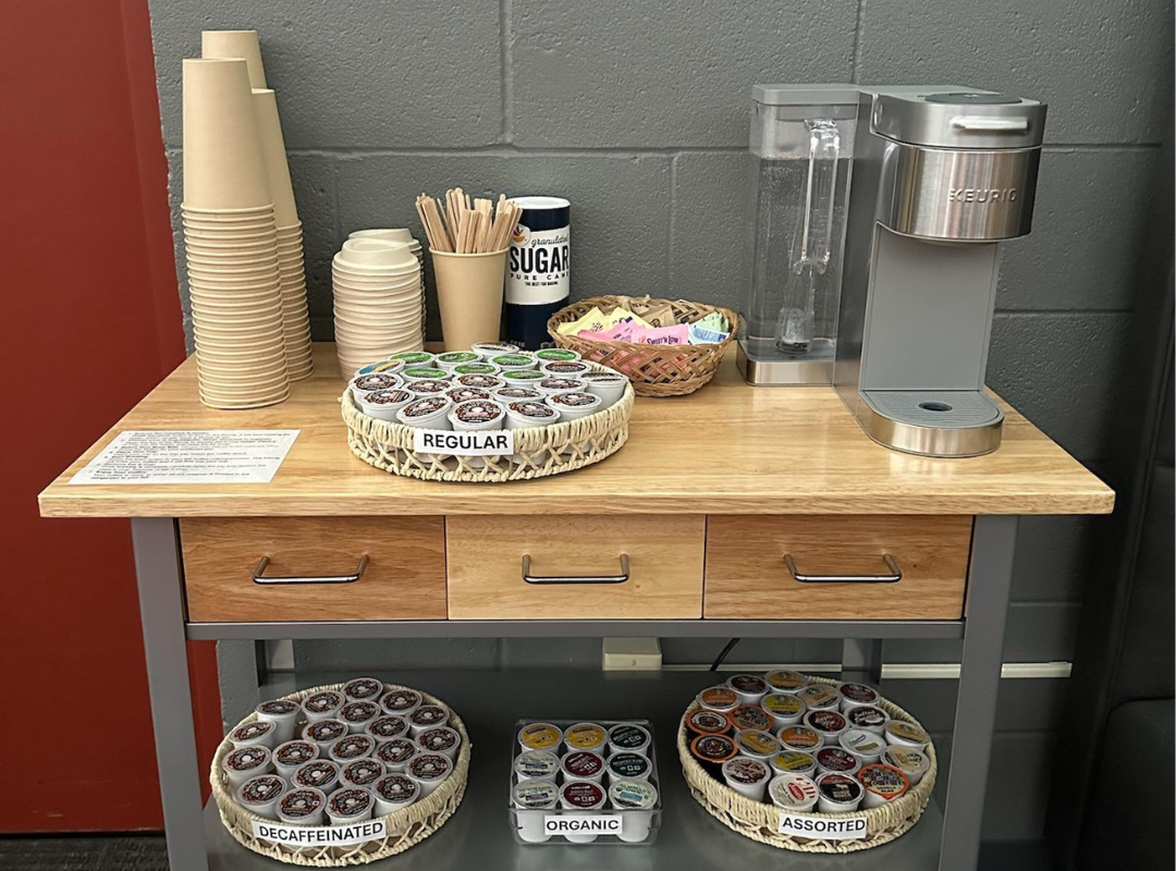 A photograph of the library's new coffee station, featuring a coffee machine and all the supplies you could need to make a delicious cup of coffee.