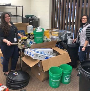 Special Collections librarian Joanna Kolosov (right) and Library specialist Elizabeth Fugere assembling the disaster response supply “cans.”