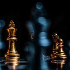 Golden chess pieces in play in a chess game.