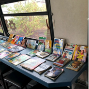 A counter on one side of the Discovery Bus absolutely filled with books laid out for kids to choose from to take one home with them when they were visiting the Discovery Bus at the 2023 North Idaho Fair.