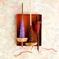 Drop spindles with wool yarn spun onto them. This linked image will take you to the calendar event in an external site and in a new tab or window.